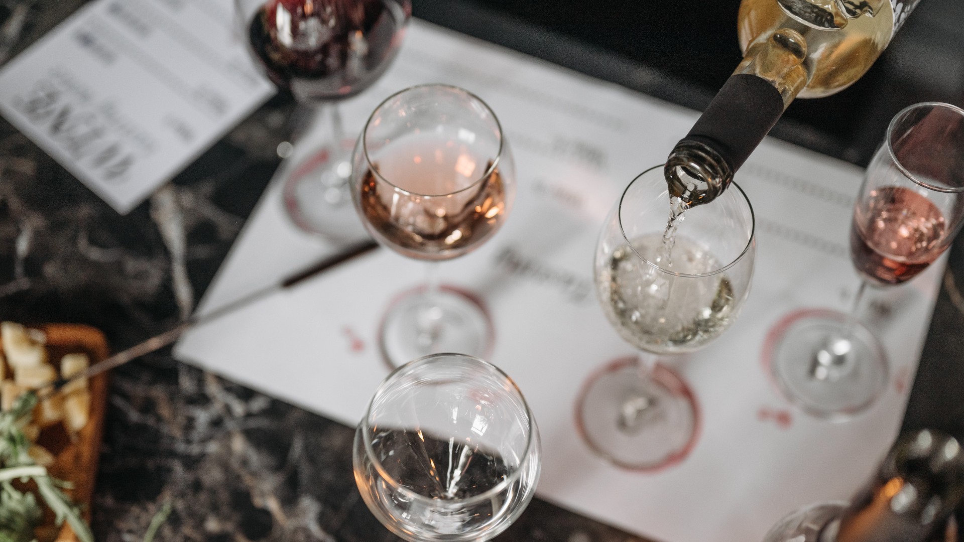 three wine glasses being poured